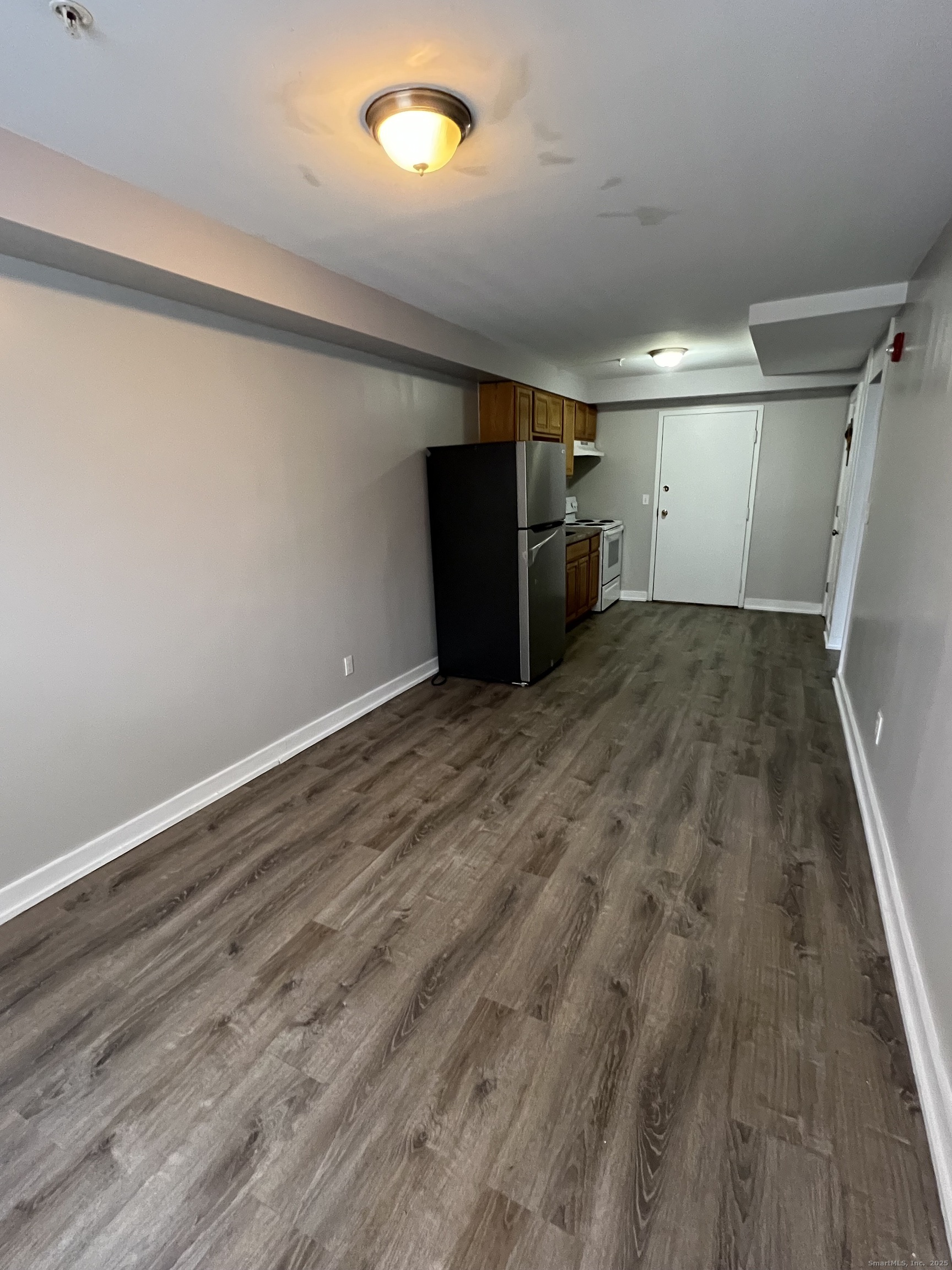 385 Putnam Avenue, Unit 5 Hamden, CT 06517 - Photo 6 of 13 a view of empty room with wooden floor