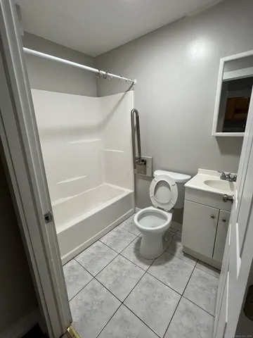 a white toilet sitting next to a bathroom sink