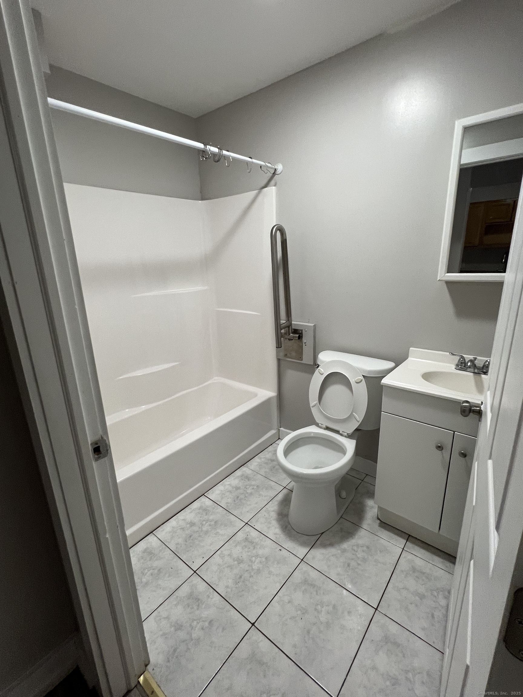 385 Putnam Avenue, Unit 5 Hamden, CT 06517 - Photo 8 of 13 a white toilet sitting next to a bathroom sink