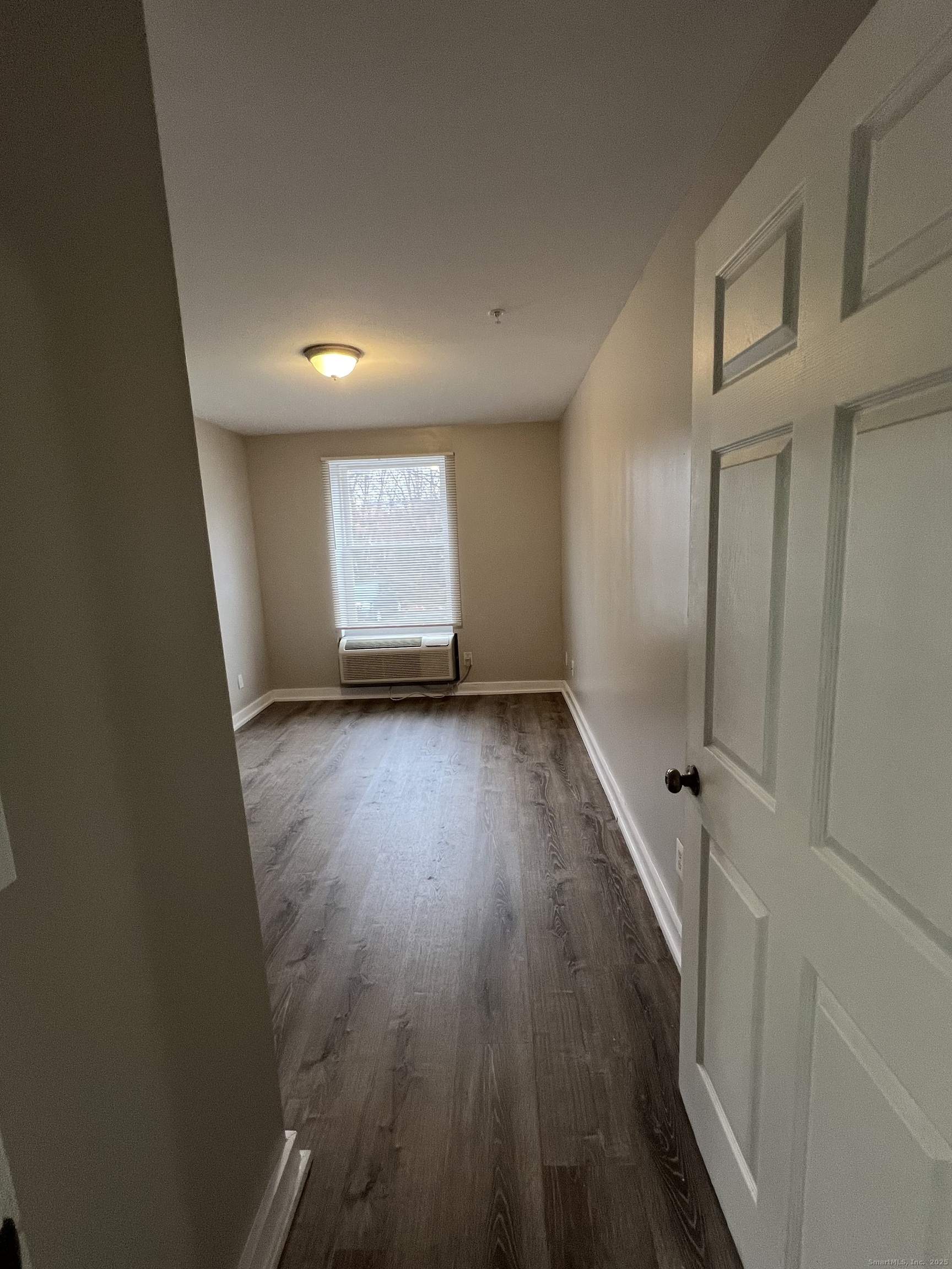385 Putnam Avenue, Unit 5 Hamden, CT 06517 - Photo 10 of 13 wooden floor in an empty room with a window