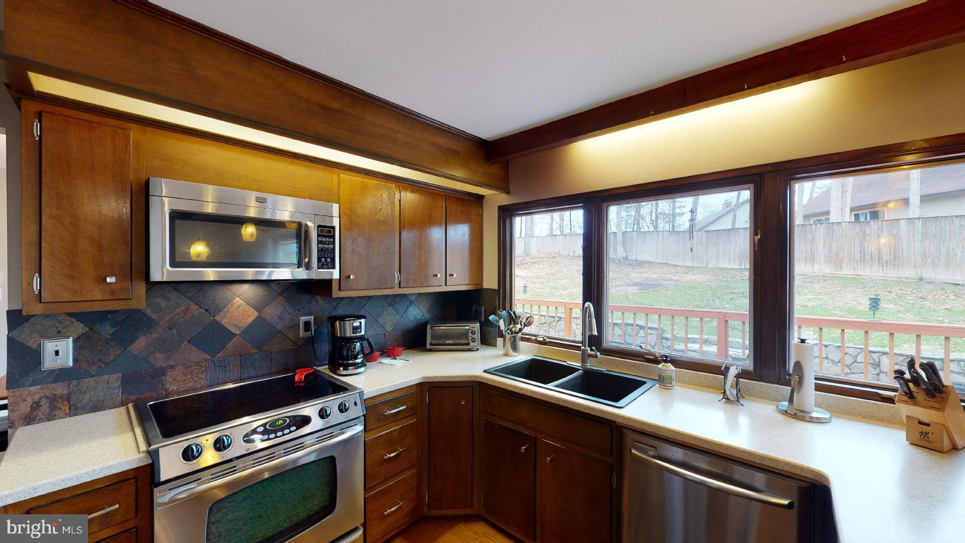 13320 Santa Anita Road Laurel, MD 20708 - Photo 11 of 32 The kitchen window overlooks the fenced yard