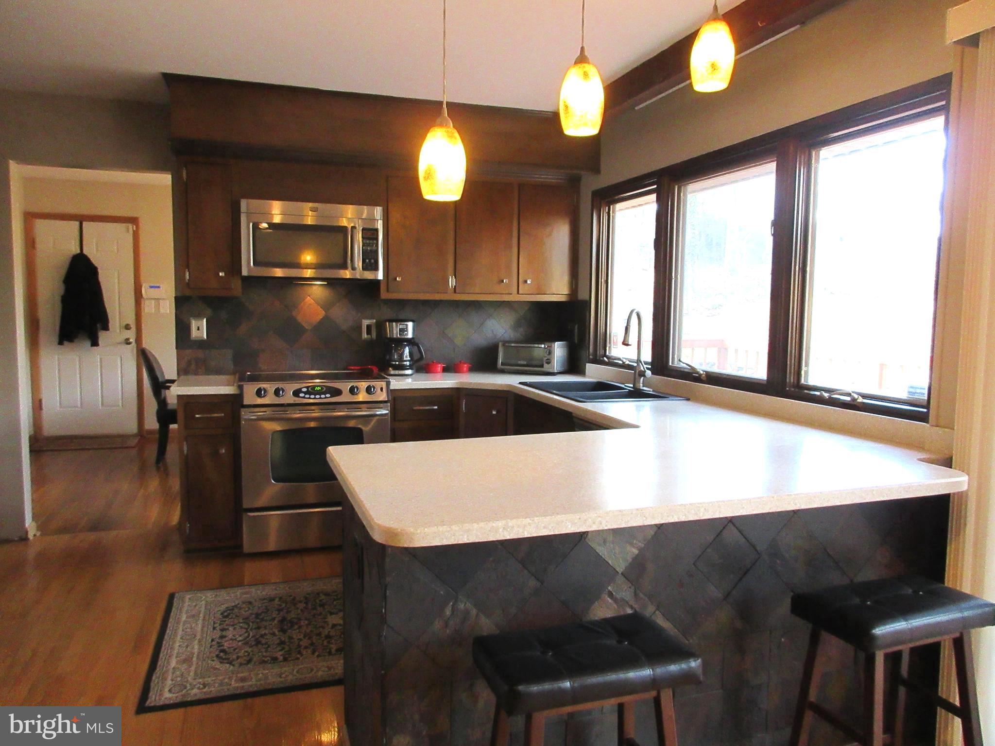 13320 Santa Anita Road Laurel, MD 20708 - Photo 8 of 32 Kitchen has Corian countertops. Breakfast bar also