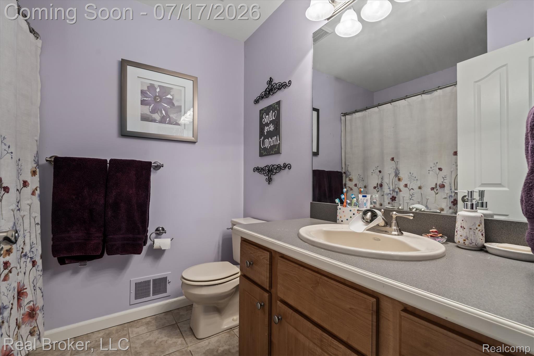 45192 Thornhill Road Canton, MI 48188 - Photo 22 of 34 Bathroom featuring a full vanity with an integrated sink, broad mirror, and overhead light fixture