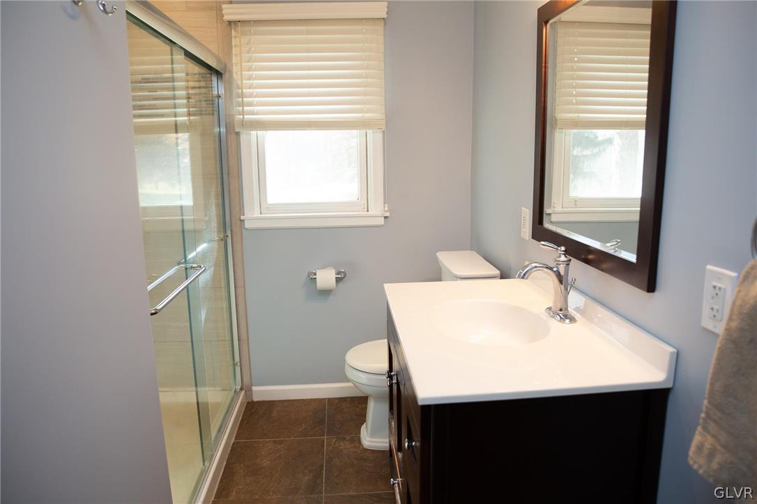1909 Blue Barn Road Orefield, PA 18069 - Photo 17 of 39 a bathroom with a sink a mirror and a window