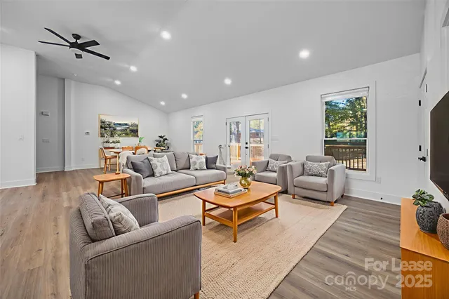a living room with furniture and a wooden floor