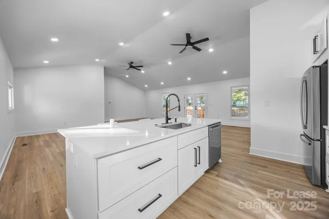 a bathroom with a sink a mirror and a shower