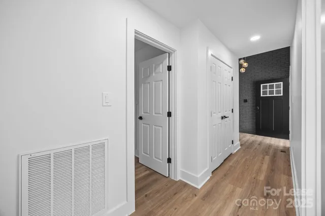 a view of hallway with wooden floor