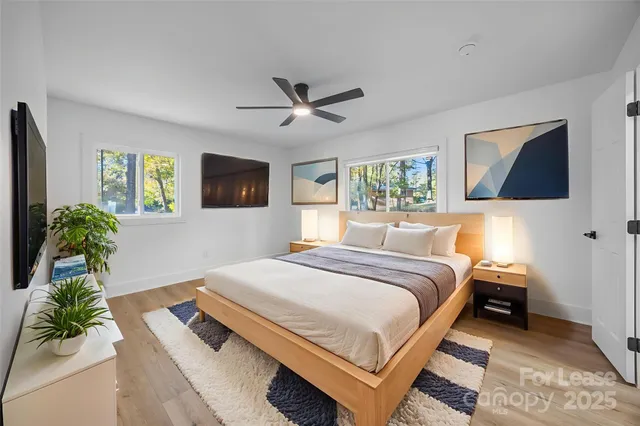 a bedroom with a large bed and a chandelier