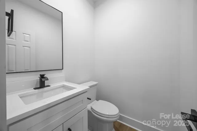 a bathroom with a sink toilet and mirror