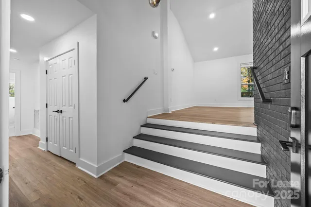 a view of entryway with wooden floor and stairs