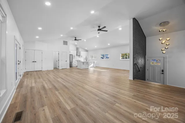 a view of a room with wooden floor