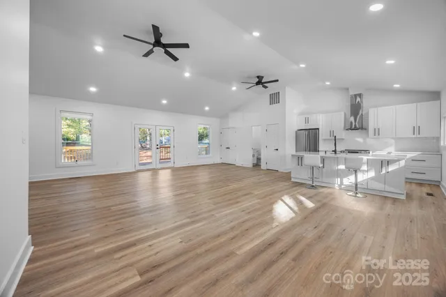 a view of center island wooden floor and windows