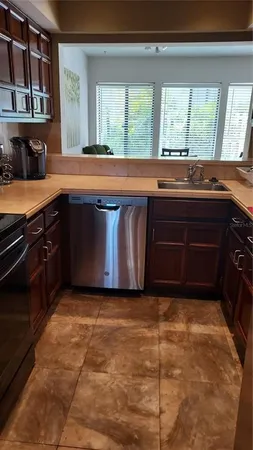 a kitchen with granite countertop a stove and a sink