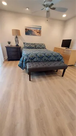 a bedroom with a bed and a ceiling fan