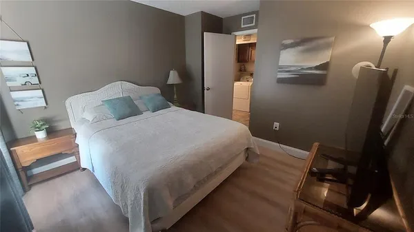 a bed room with a bed and a television