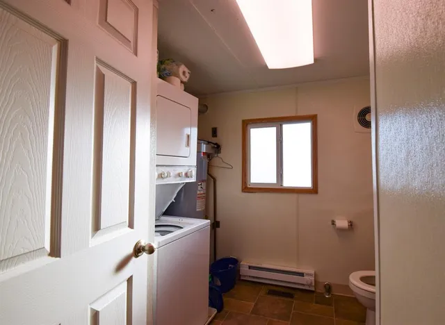 a kitchen with a refrigerator and a window