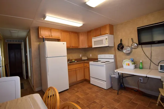 a kitchen with stainless steel appliances a refrigerator stove top oven a sink and dishwasher