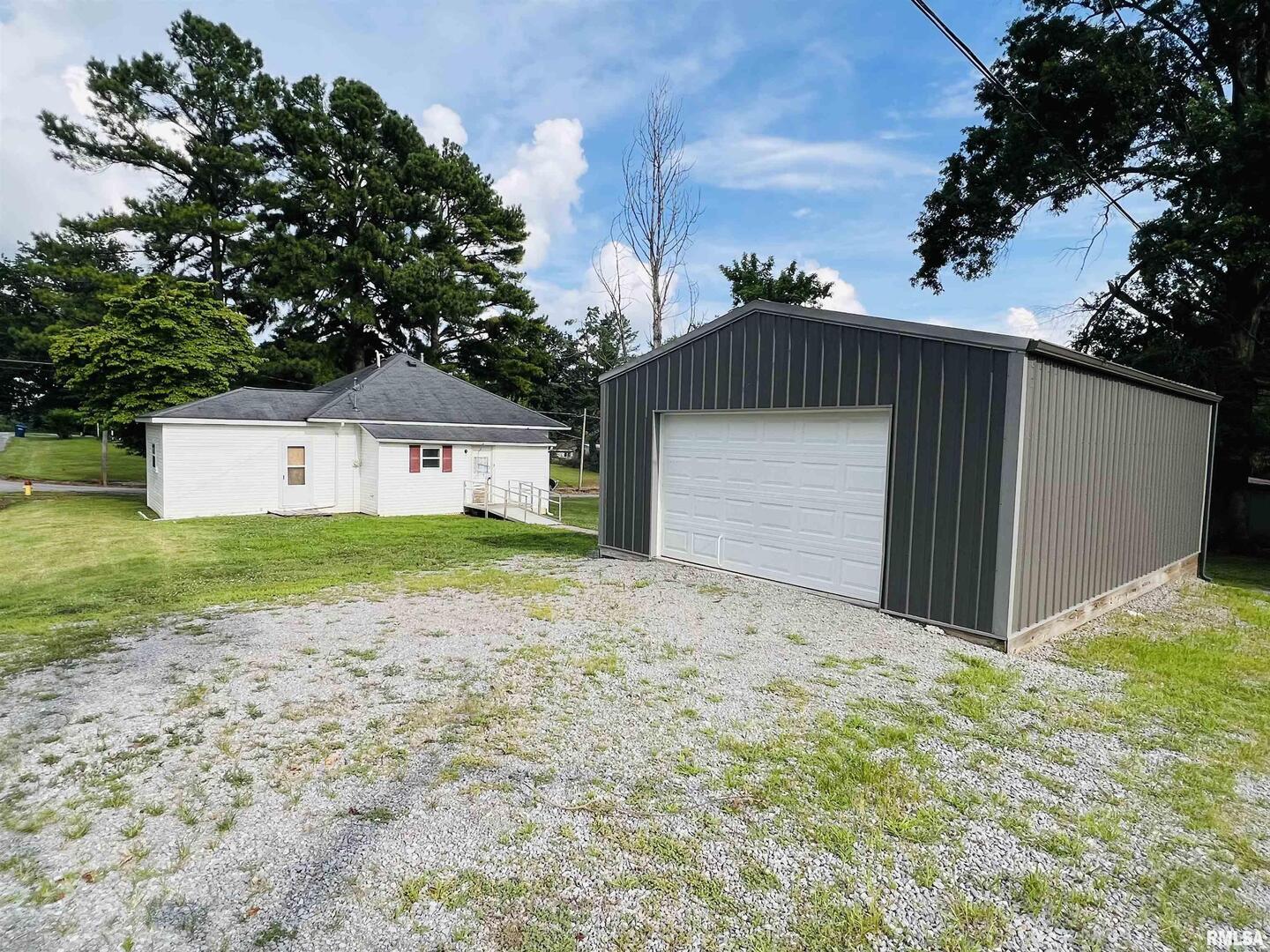 2417 1st Street Eldorado, IL 62930 - Photo 18 of 21 a front view of house with yard and trees in the background