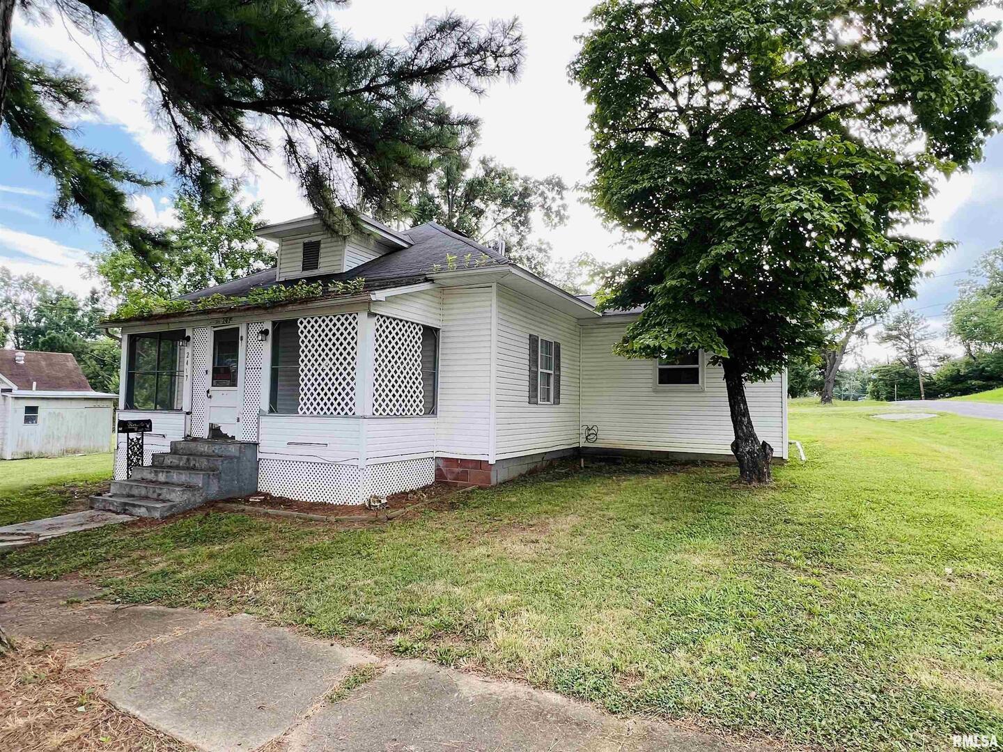2417 1st Street Eldorado, IL 62930 - Photo 2 of 21 a view of a house with a yard and sitting area