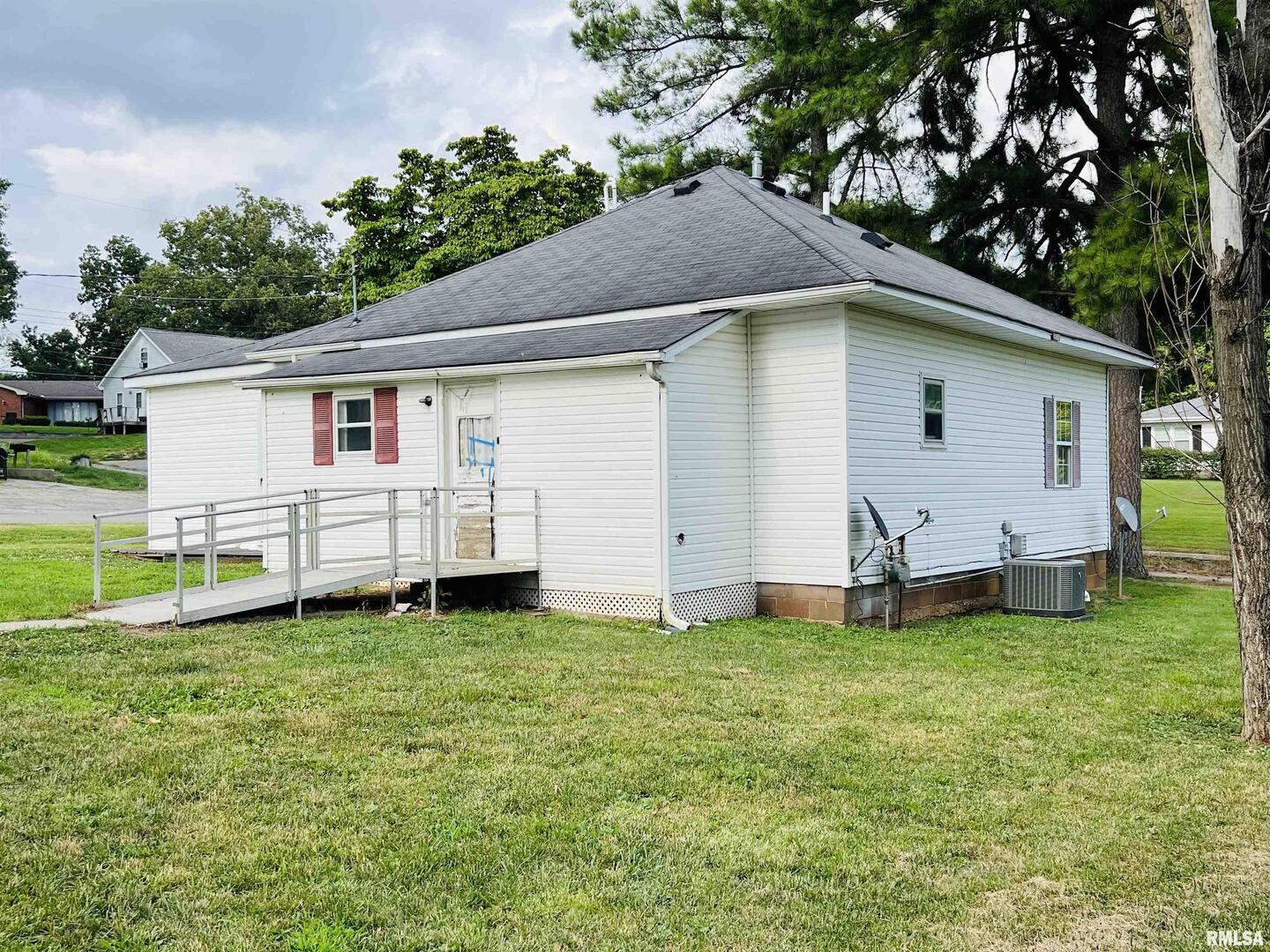 2417 1st Street Eldorado, IL 62930 - Photo 5 of 21 a white house that has a tree in front of it