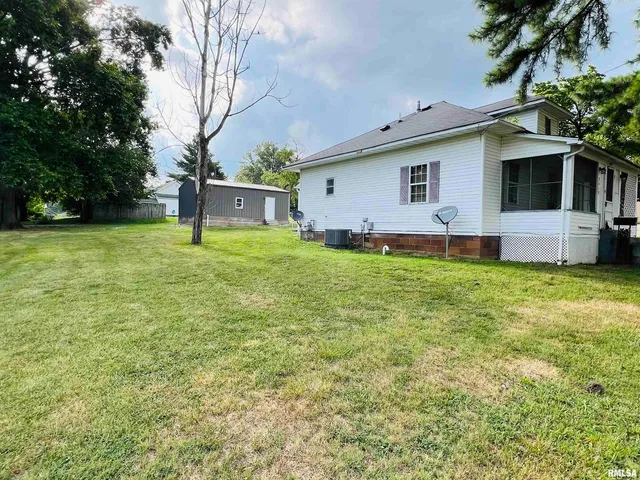 a front view of house with a garden