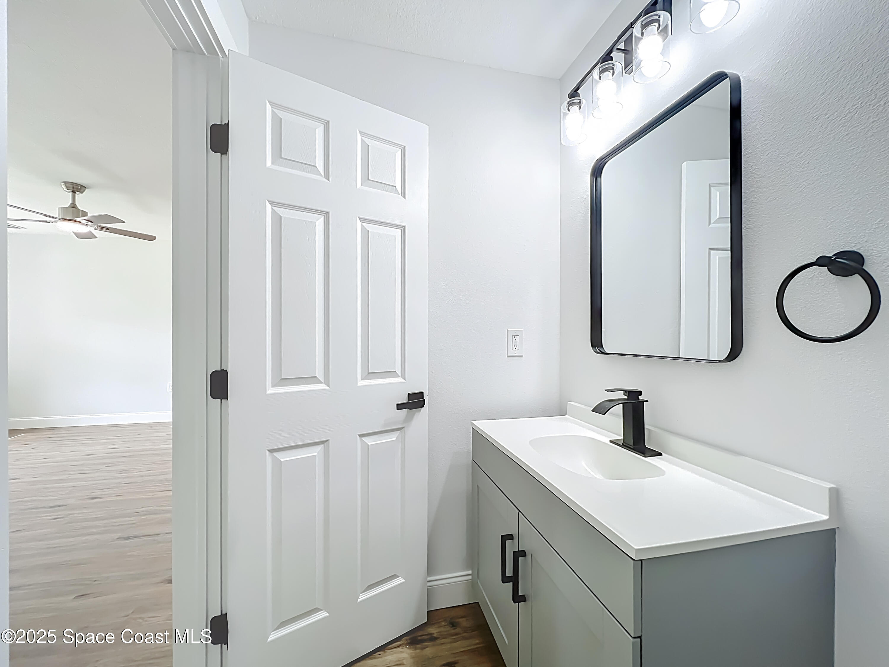 2340 Iowa Drive Melbourne, FL 32935 - Photo 17 of 47 a bathroom with a double vanity sink and a mirror