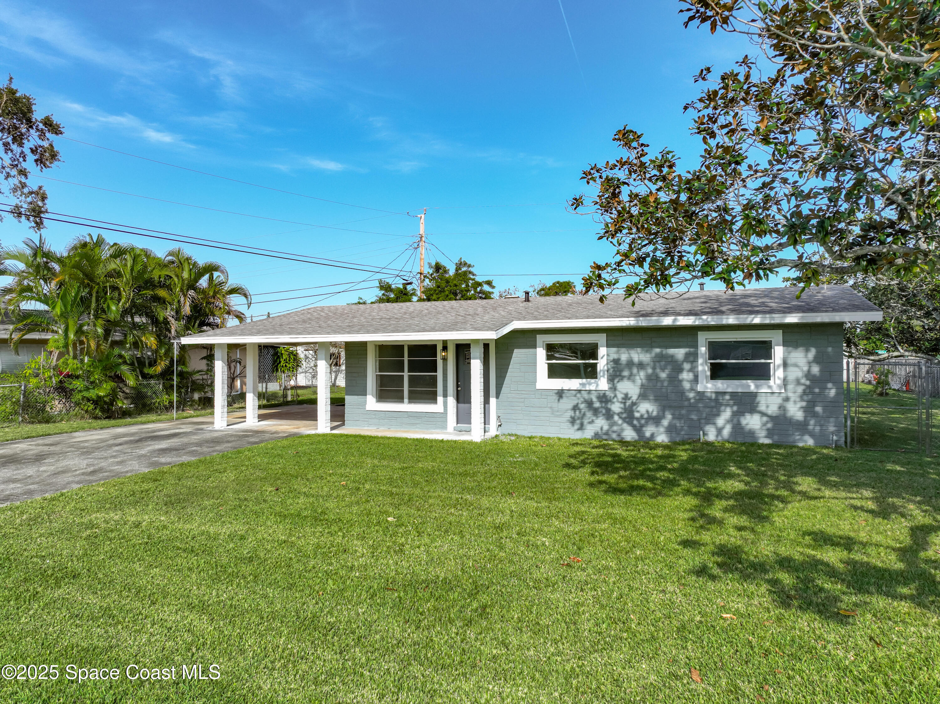 2340 Iowa Drive Melbourne, FL 32935 - Photo 2 of 47 a front view of a house with a garden
