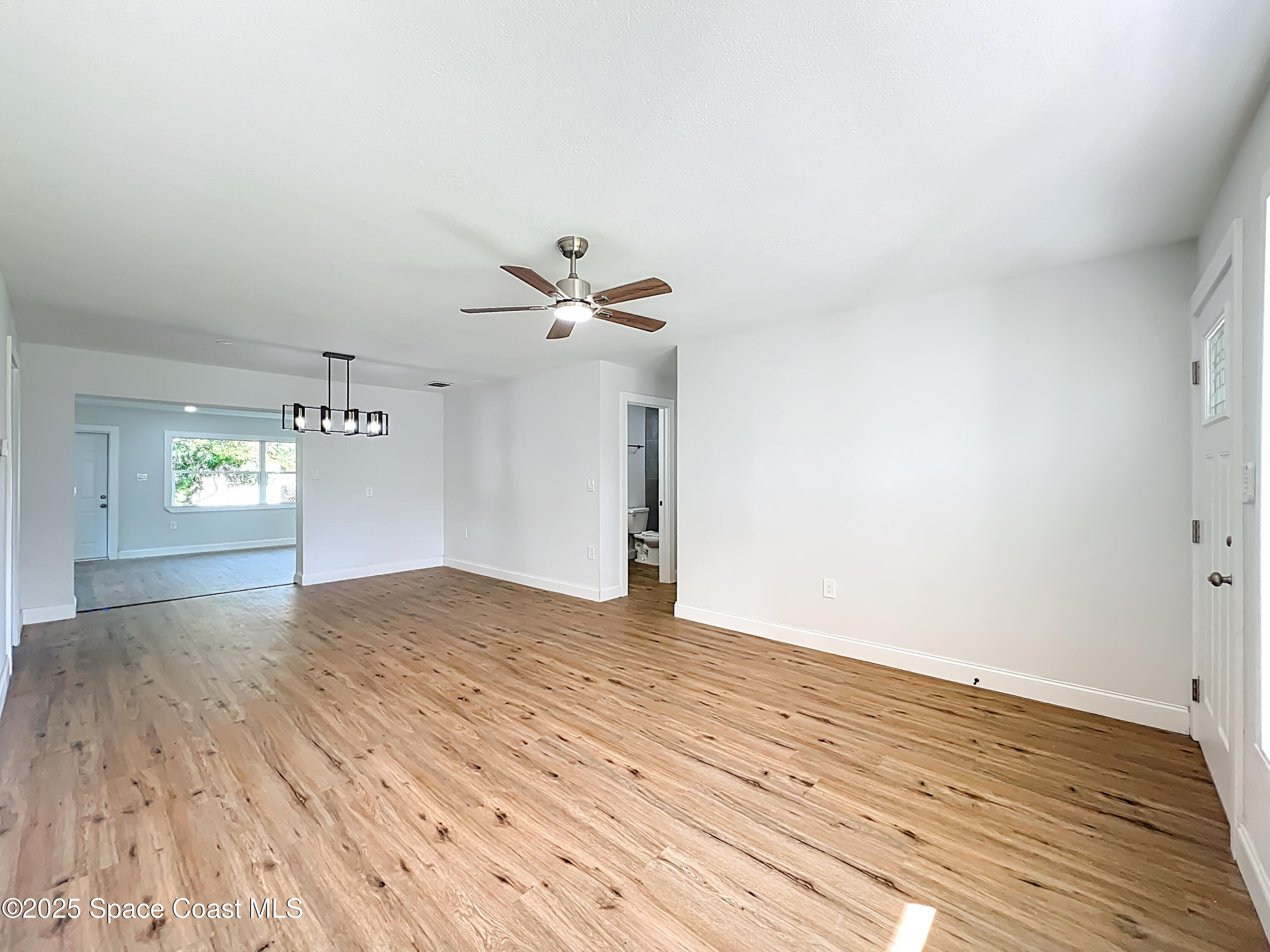 2340 Iowa Drive Melbourne, FL 32935 - Photo 23 of 47 a view of empty room with wooden floor