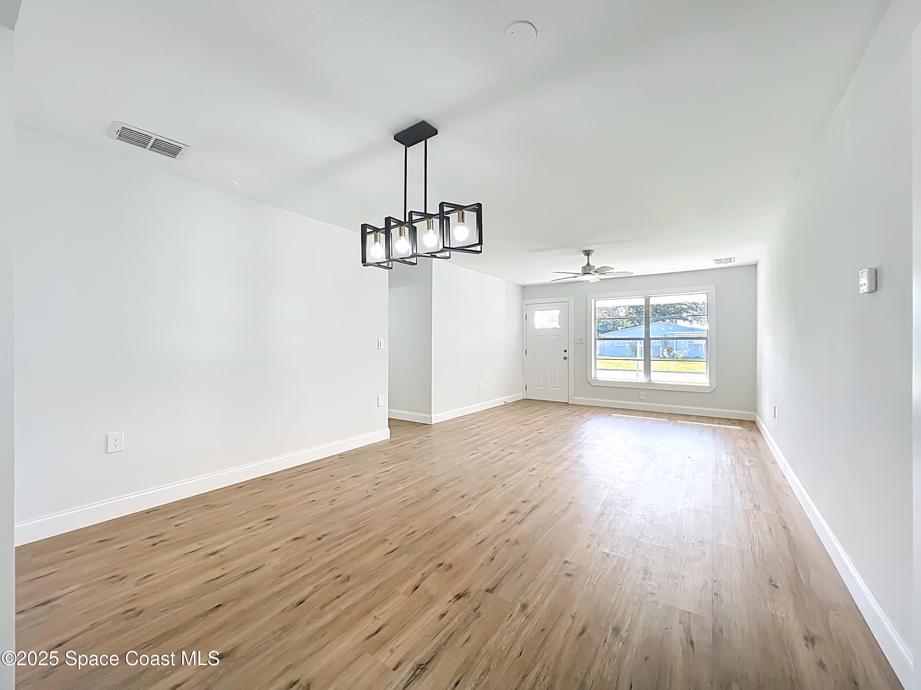 2340 Iowa Drive Melbourne, FL 32935 - Photo 24 of 47 wooden floor in an empty room with a window