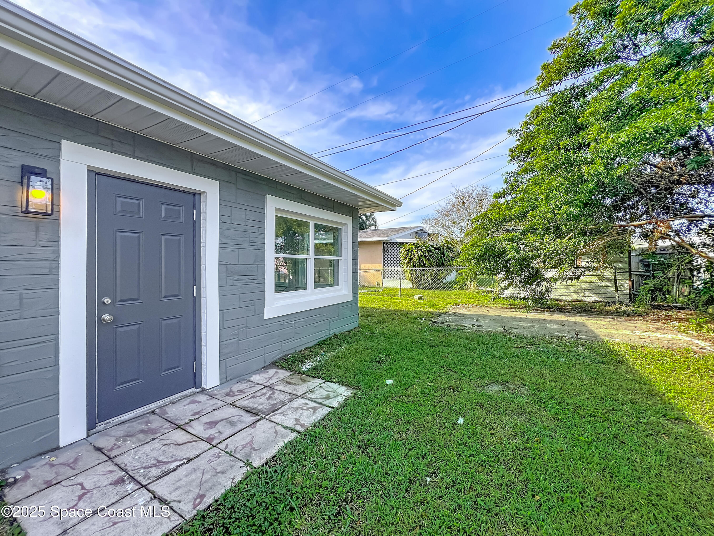 2340 Iowa Drive Melbourne, FL 32935 - Photo 40 of 47 a view of backyard with a garden and trees