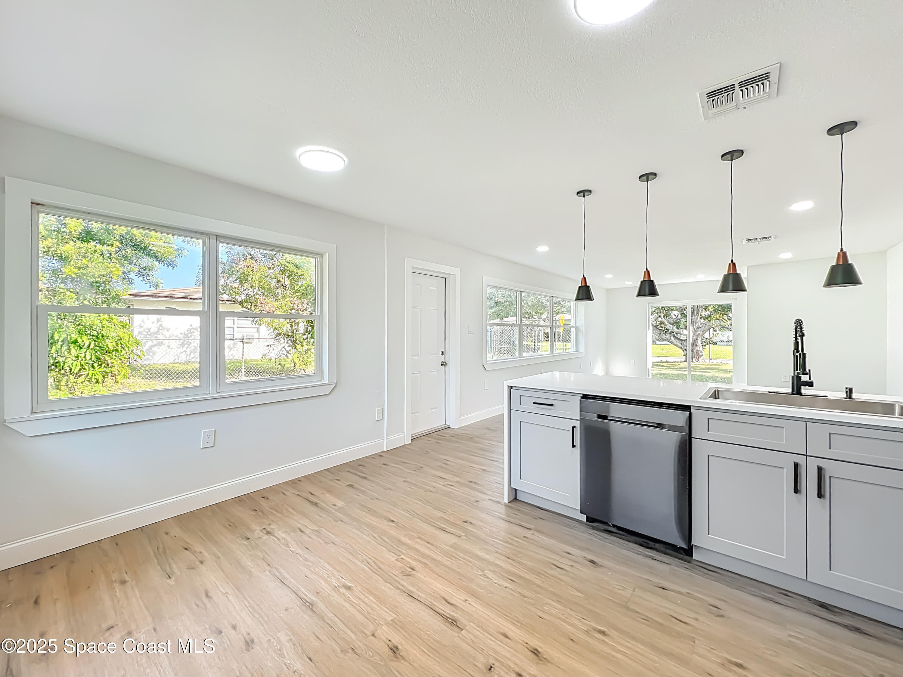 2340 Iowa Drive Melbourne, FL 32935 - Photo 7 of 47 a kitchen with stainless steel appliances granite countertop hardwood floor sink stove and granite counter top