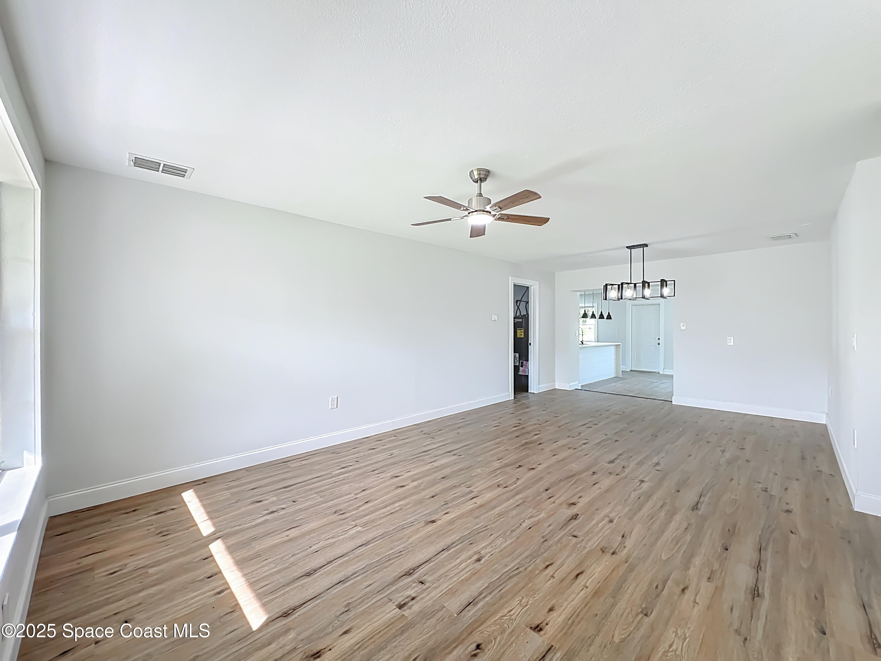 2340 Iowa Drive Melbourne, FL 32935 - Photo 10 of 47 a view of empty room with wooden floor