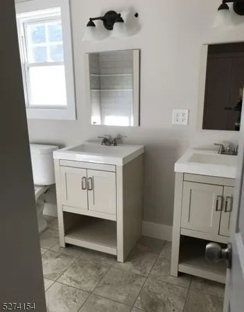 a bathroom with a sink toilet and mirror