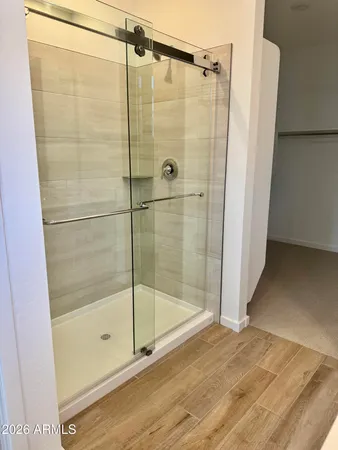 a bathroom with a glass shower door