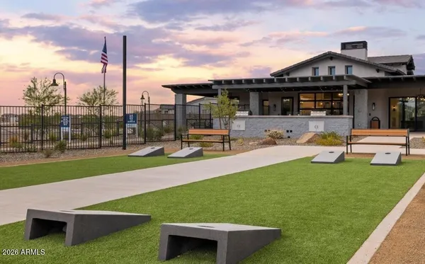 a front view of a house with garden and sitting area