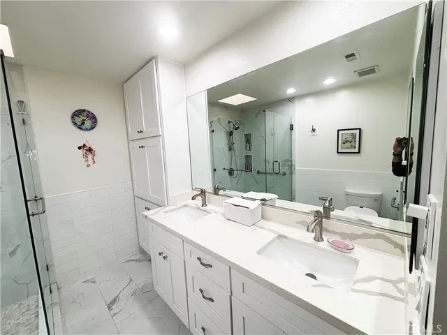 a bathroom with double vanity sink and mirror