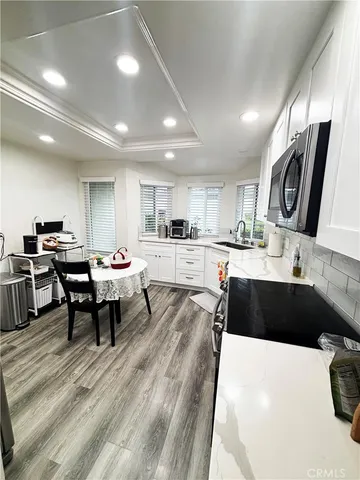 a large kitchen with kitchen island a sink a counter space and stainless steel appliances