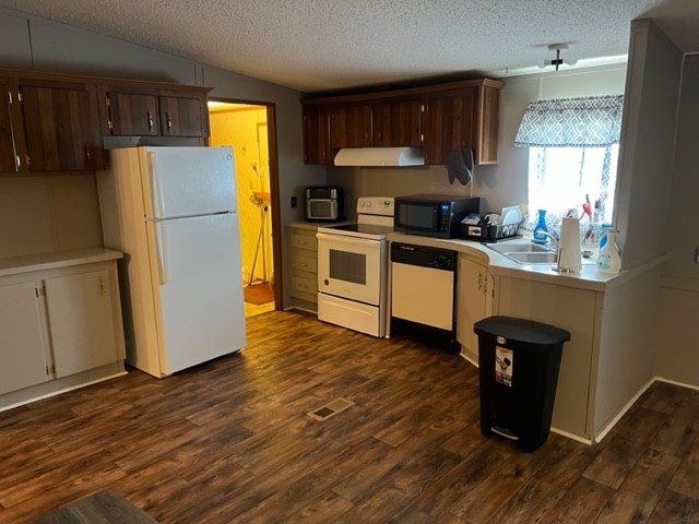147 Philpot Road Ardmore, TN 38449 - Photo 15 of 21 a kitchen with granite countertop wooden floors a stove and a refrigerator