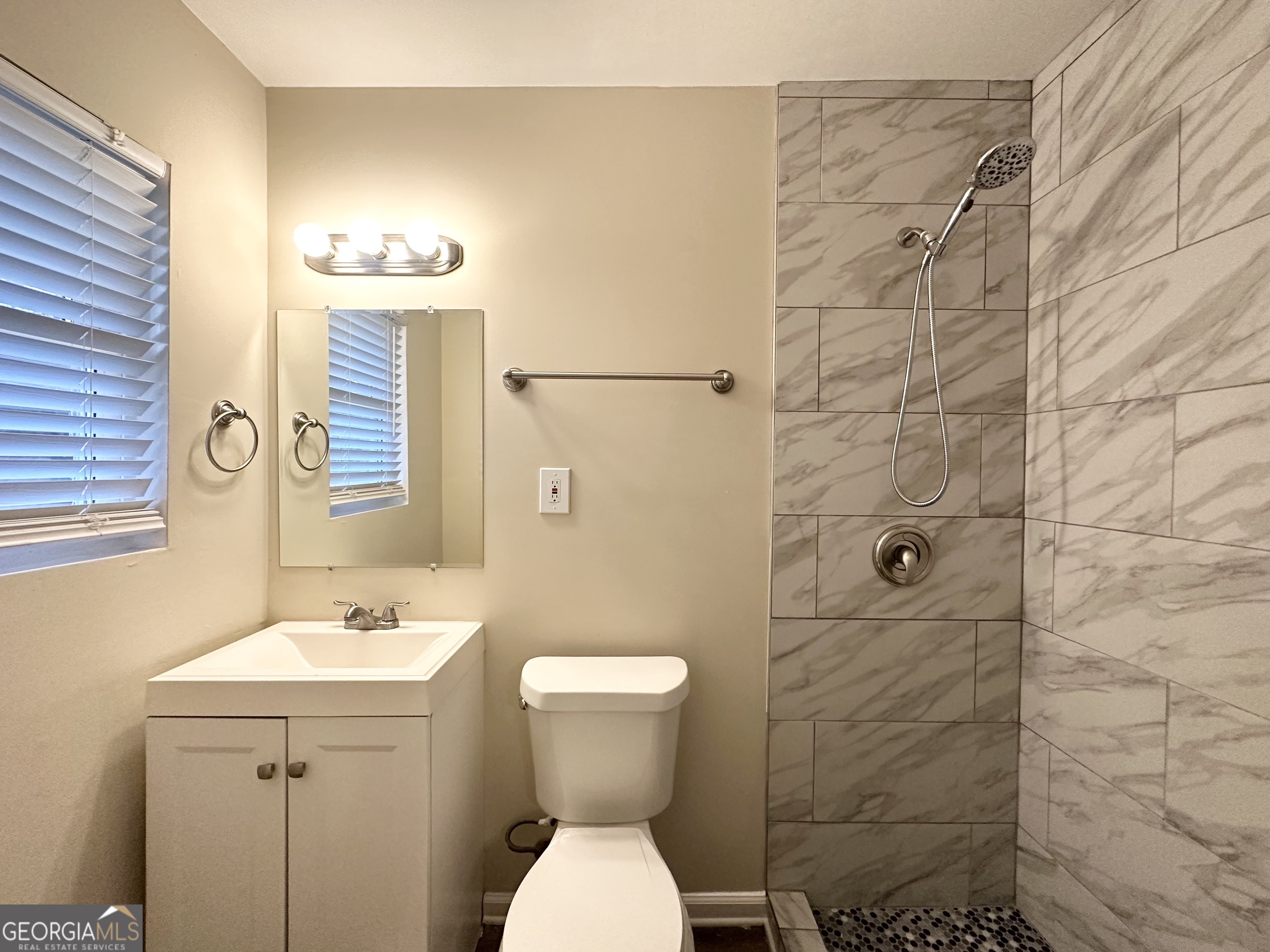310 Flagstone Drive Southwest Atlanta, GA 30331 - Photo 12 of 13 a bathroom with a toilet sink shower and mirror