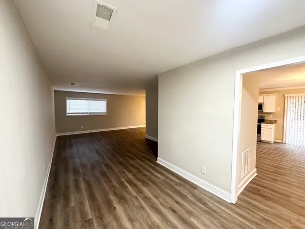 a view of wooden floor and windows in a room