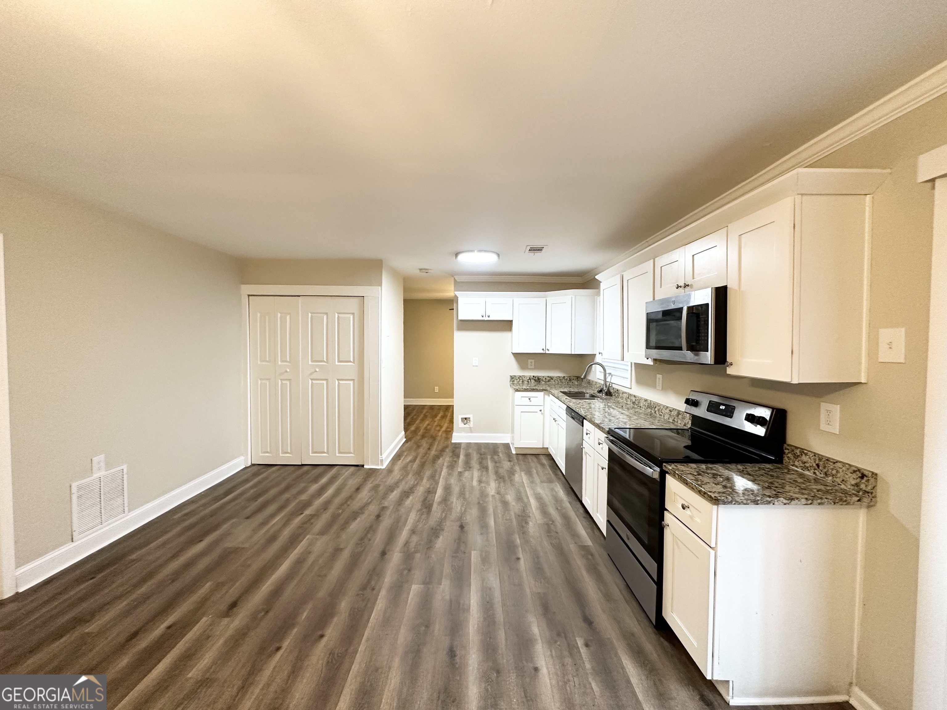 310 Flagstone Drive Southwest Atlanta, GA 30331 - Photo 6 of 13 a kitchen with stainless steel appliances a stove top oven a sink dishwasher and a microwave with wooden floor