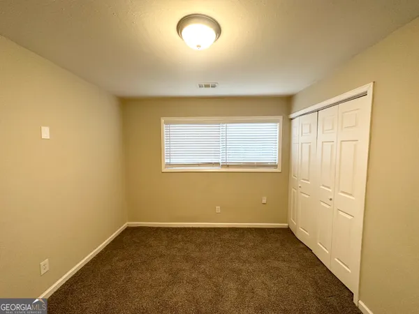 an empty room with a empty space and windows