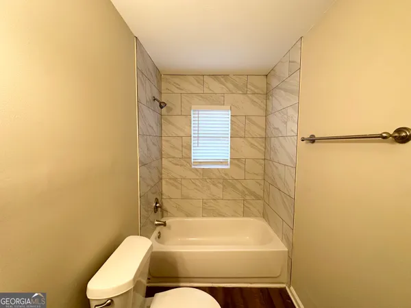 a bathroom with a toilet and bathtub