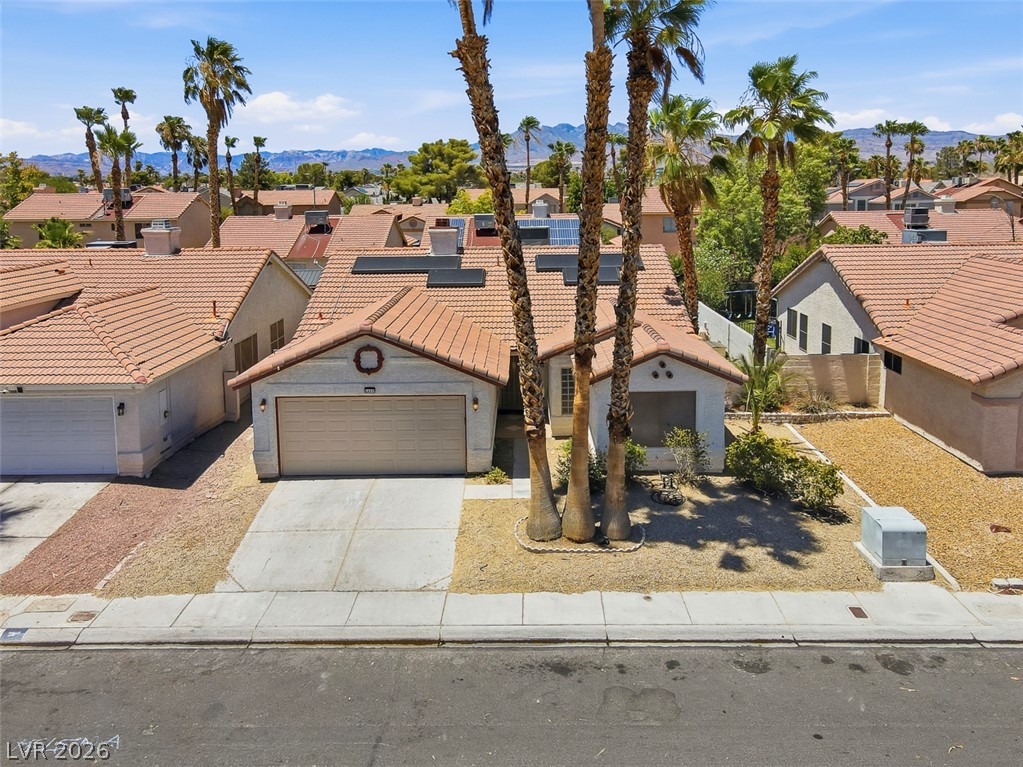 2609 Shakespeare Road Las Vegas, NV 89108 - Photo 37 of 41 Palm trees frame this home with a tile roof and attached garage.