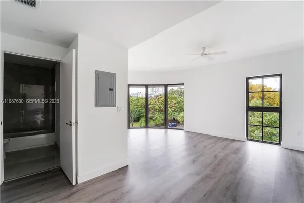wooden floor in an empty room with a window