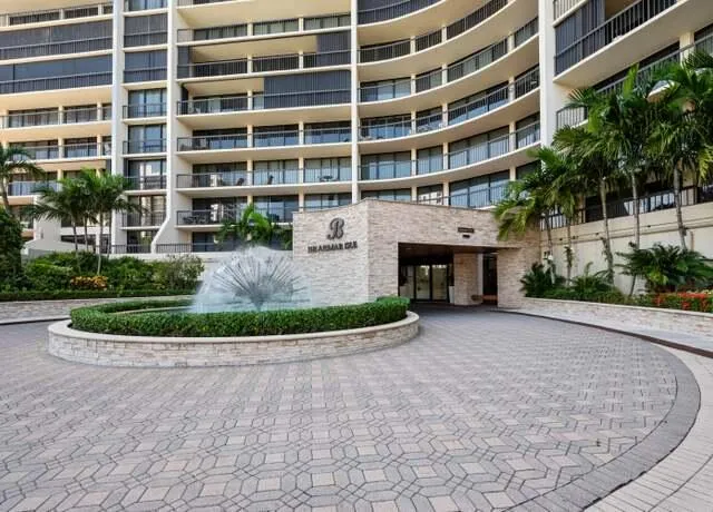 a view of large kitchen with granite countertop a large counter top appliances and cabinets