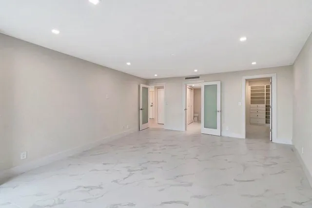 a bathroom with a shower and a glass door