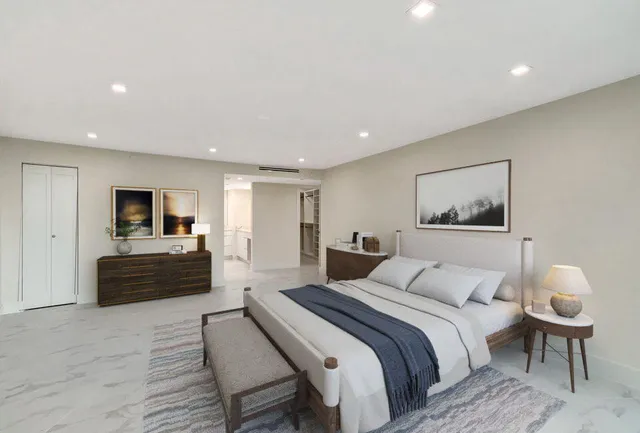 a bedroom with a large bed and a flat screen tv