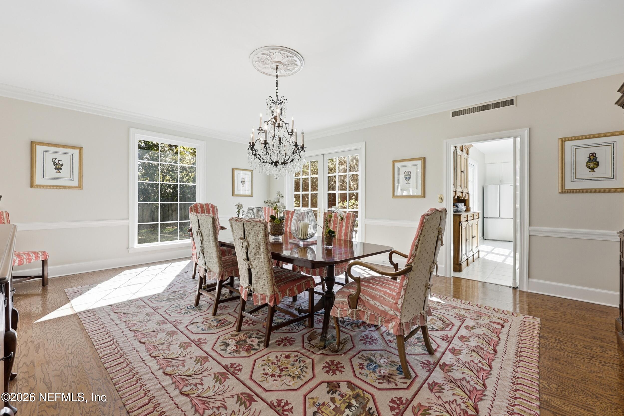 4706 Ivanhoe Road Jacksonville, FL 32210 - Photo 11 of 47 a view of a dining room with furniture window and wooden floor