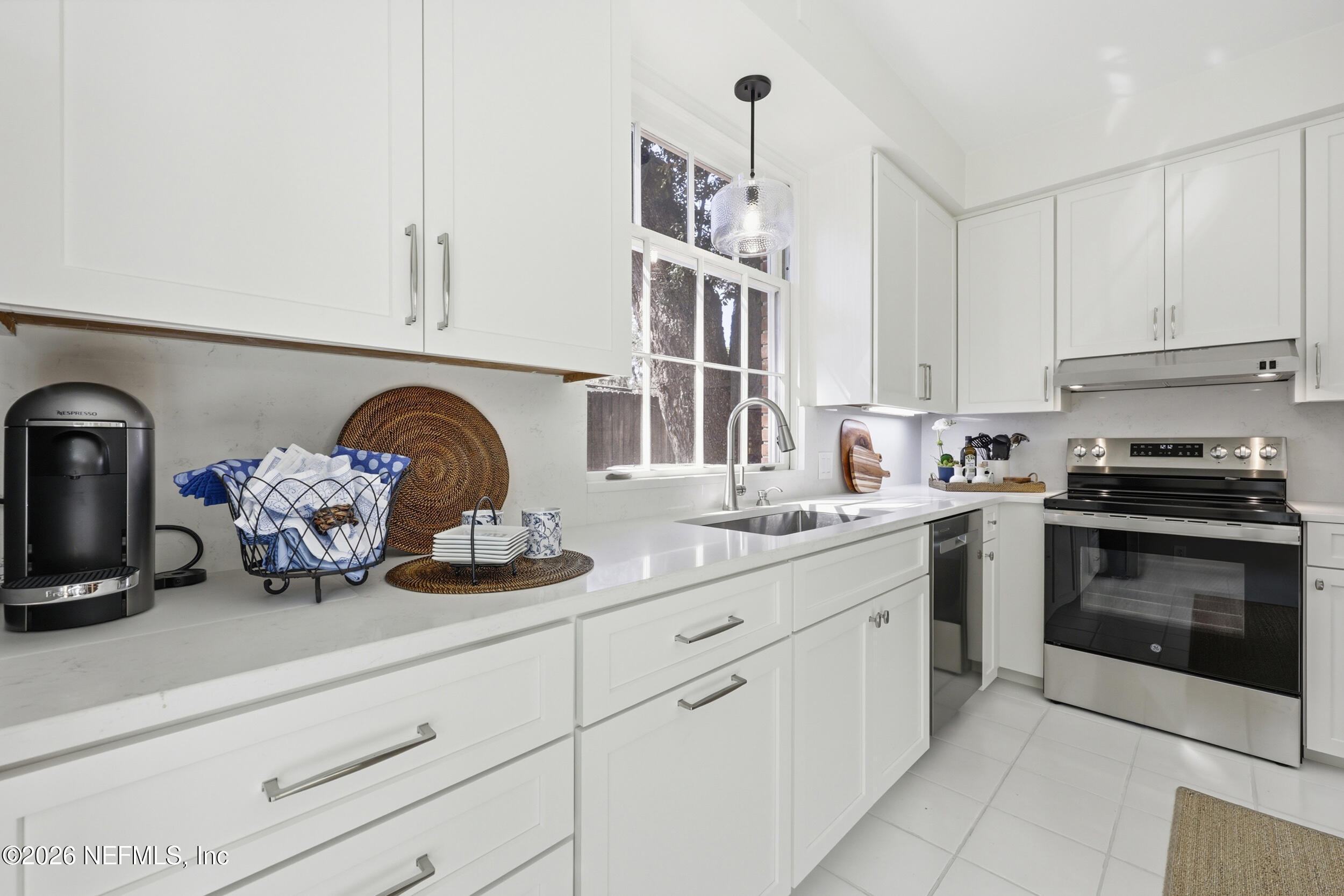 4706 Ivanhoe Road Jacksonville, FL 32210 - Photo 14 of 47 a kitchen with white cabinets and appliances
